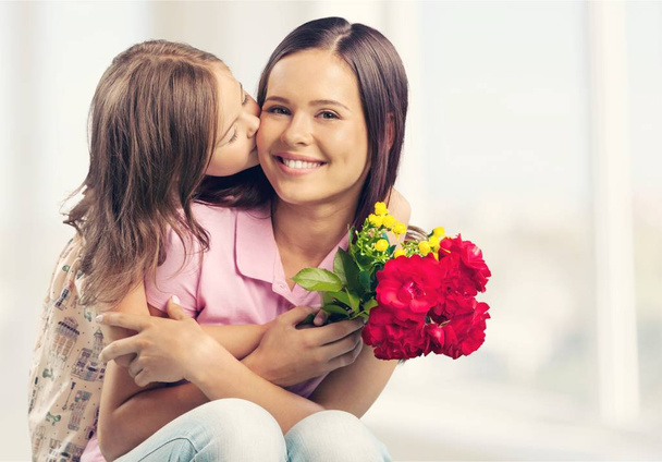 Mother and daughter with flowers - Foto, imagen