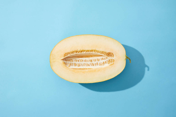 vue de dessus de melon frais mûr savoureux sur fond bleu
  - Photo, image