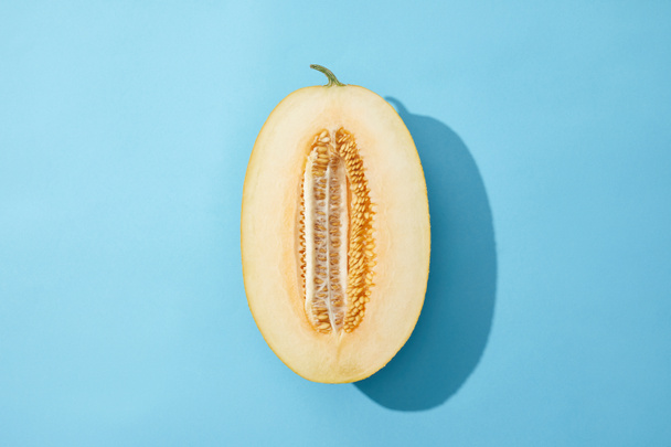 top view of fresh ripe sweet melon on blue background  - 写真・画像