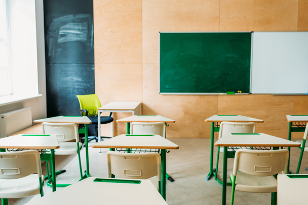 interior of empty modern classroom with blank chalkboard at school - Photo, Image