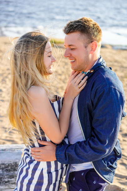 happy romantic couple in love on sandy beach with sea on background - Фото, зображення