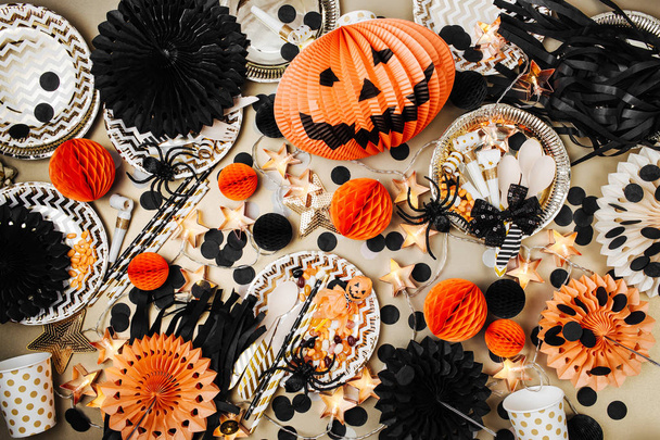 top view of table with Halloween decorations and plates with candies - Fotografie, Obrázek