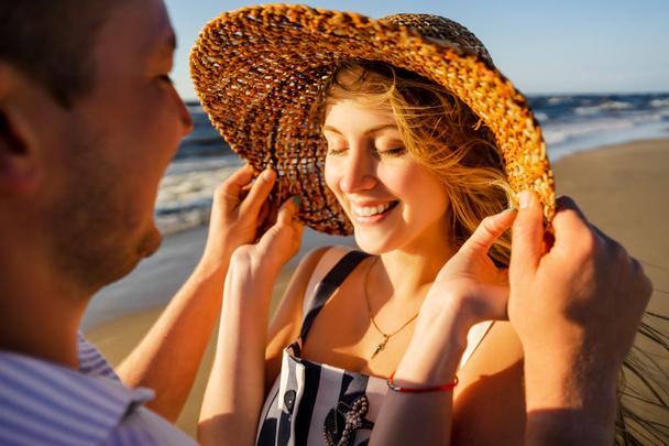 smiling couple in love on seashore on summer day in Riga, Latvia - Photo, Image