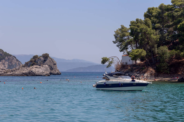 View of the moored, small boat, mountains, sea and islets in the distance (resort city Parga, region of Epirus, Greece) - Photo, Image
