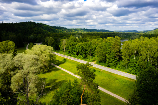 vista panoramica di cielo azzurro nuvoloso, strada e alberi verdi, Riga, Lettonia
 - Foto, immagini
