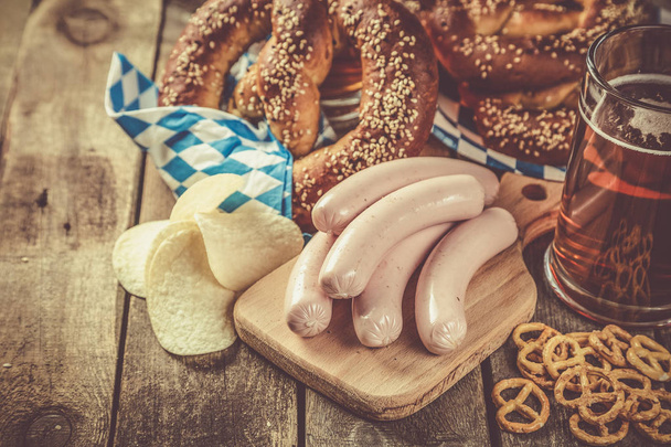 Oktoberfest concept - traditional food and beer on rustic background, copy space - Фото, изображение
