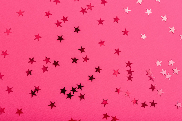 Star sprinkles on pink. Festive holiday background. Celebration concept. Top view, flat lay. - Fotografie, Obrázek