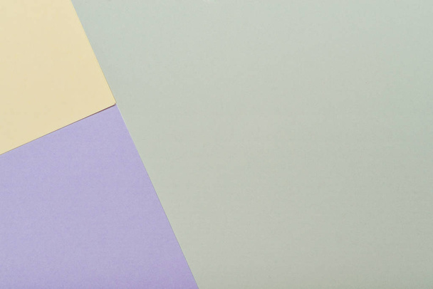 Yellow, green and violet pastel color paper geometric flat lay backgroun - 写真・画像