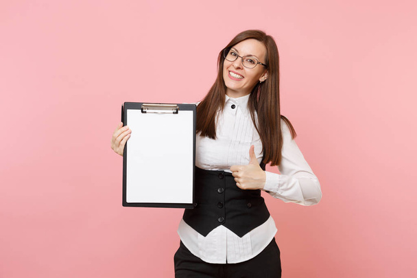Young pleasant business woman showing thumb up holding clipboard tablet with blank empty sheet workspace copy space isolated on pink background. Lady boss. Achievement career wealth. Advertising area - Photo, Image