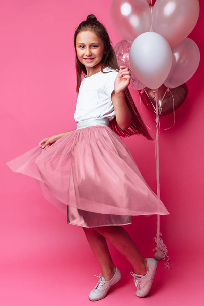 teen girl in beautiful dress on pink background - Фото, изображение