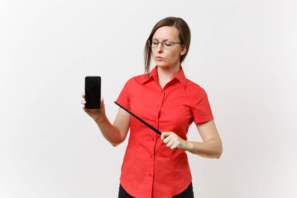 Strict severe serious teacher woman user in red shirt hold mobile smart phone with blank empty screen to copy space isolated on white background. Education teaching in high school university concept - Fotoğraf, Görsel