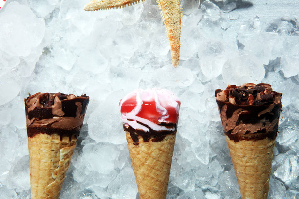 ice cream in waffle cone and strawberry, raspberry and chocolate softice cream - Photo, Image