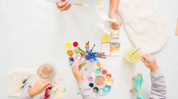 Pas à pas. Petites filles peinture papier mache licorne avec peinture acrylique
. - Photo, image