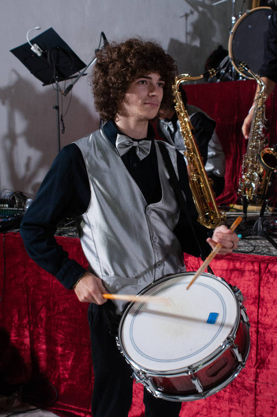 young drummer while testing his musical instrument, handsome guy while testing his instrument, snare drum - Foto, Bild
