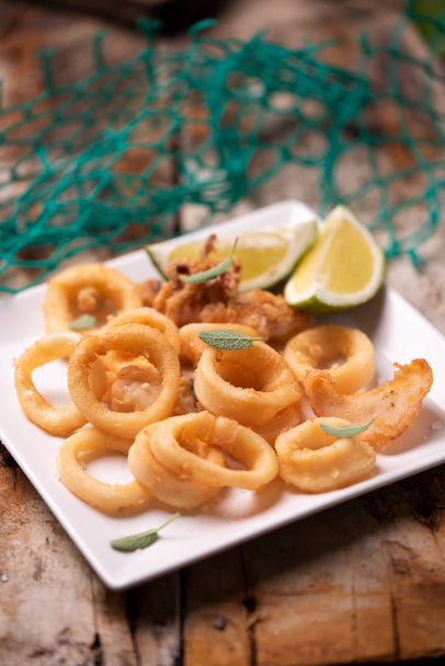 Golden fried calamari squid sreved on a plate - Photo, Image
