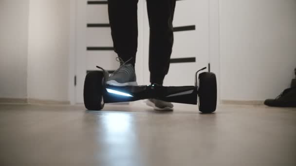 Close-Up Nézd férfi láb lépve elektromos hyroscooter a modern irodák a fehér falak és a szülőkhöz. - Felvétel, videó