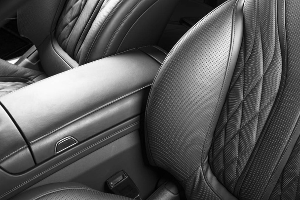 AC Ventilation Deck in Luxury modern Car Interior. Modern car interior details with leather stitching. Carbon panel. Perforated leather steering wheel. Black and white - Foto, afbeelding