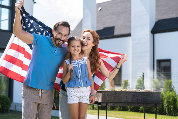 Joyful positive family celebrating the Independence Day - Фото, изображение
