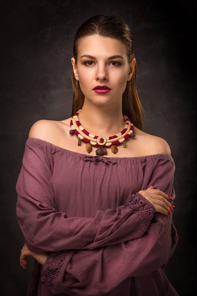Beautiful young female brunette model in handmade accessories fashion jewelry necklace. Looking at camera. - Valokuva, kuva