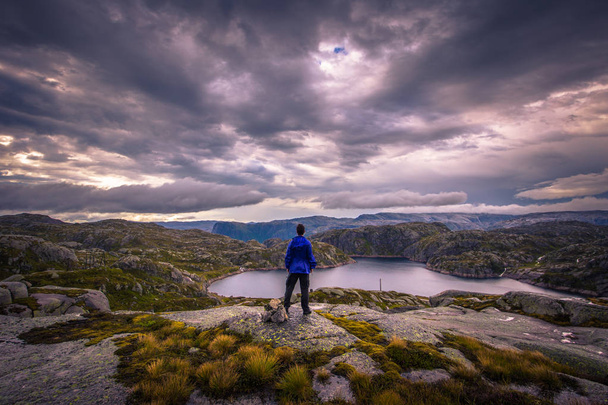 Norway- July 31, 2018: Traveler in the landscape near the Kjerag rock, Norway - Foto, Imagem