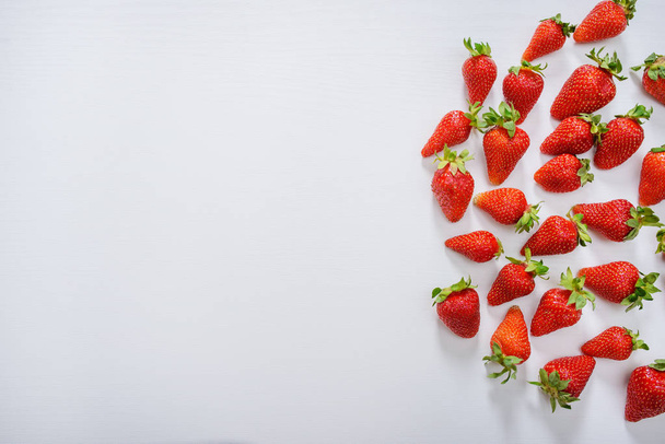 strawberry fruits on the right side on wooden background with copy space. View from above - Фото, зображення