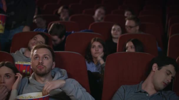 Bored audience leaving cinema while session in slow motion. Uninteresting film - Footage, Video