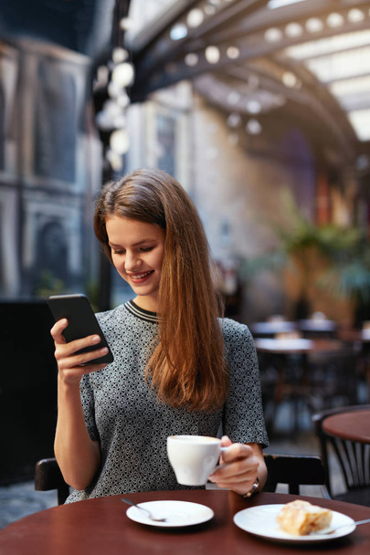 Woman With Mobile Phone In Cafe - Foto, Bild