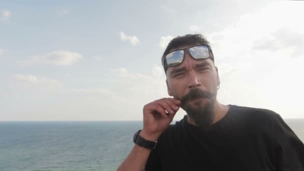 Dude beatnik with mustache, and glasses on the background of the sea. Movember - Footage, Video