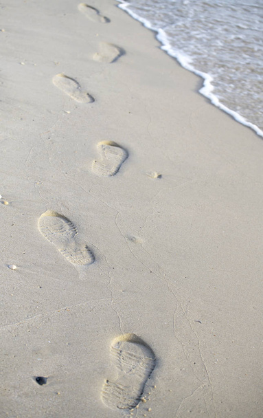 Footprints walking on the beach by the morning - Photo, Image