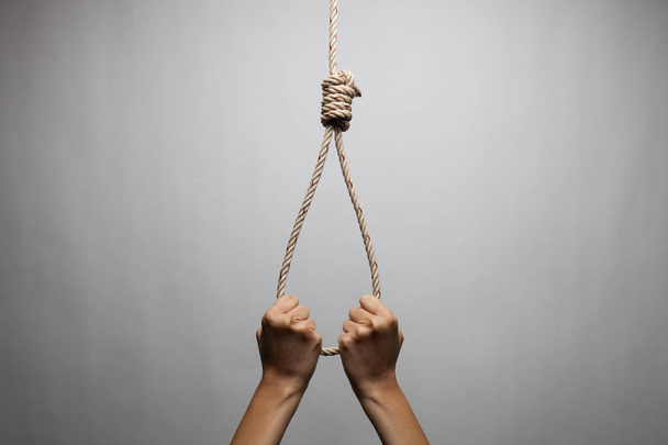 Hands holding rope slipknot in concept suicide - Foto, Imagen