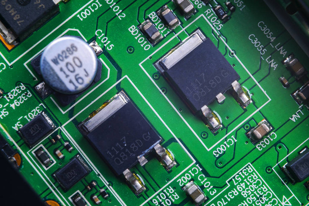 Macro shot of a Circuitboard with resistors microchips and electronic components. Computer hardware technology. Integrated communication processor. Information engineering. Semiconductor. PCB. Closeup - Foto, immagini
