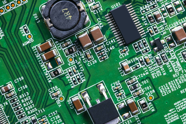 Macro shot of a Circuitboard with resistors microchips and electronic components. Computer hardware technology. Integrated communication processor. Information engineering. Semiconductor. PCB. Closeup - Zdjęcie, obraz