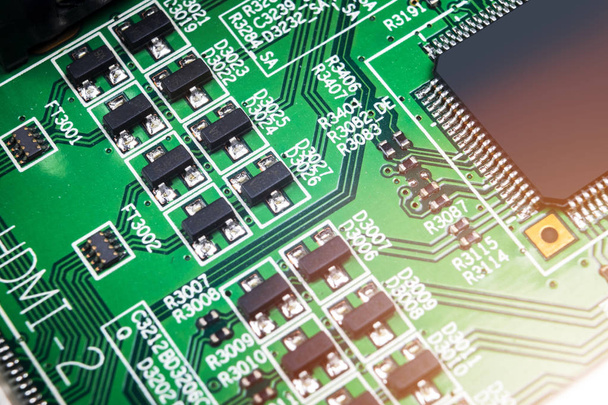 Macro shot of a Circuitboard with resistors microchips and electronic components. Computer hardware technology. Integrated communication processor. Information engineering. Semiconductor. PCB. Closeup - 写真・画像