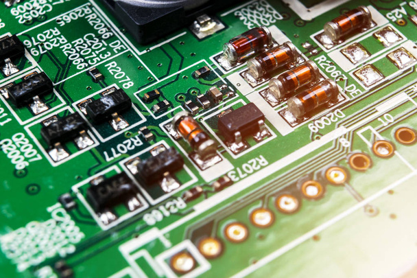 Macro shot of a Circuitboard with resistors microchips and electronic components. Computer hardware technology. Integrated communication processor. Information engineering. Semiconductor. PCB. Closeup - Фото, изображение