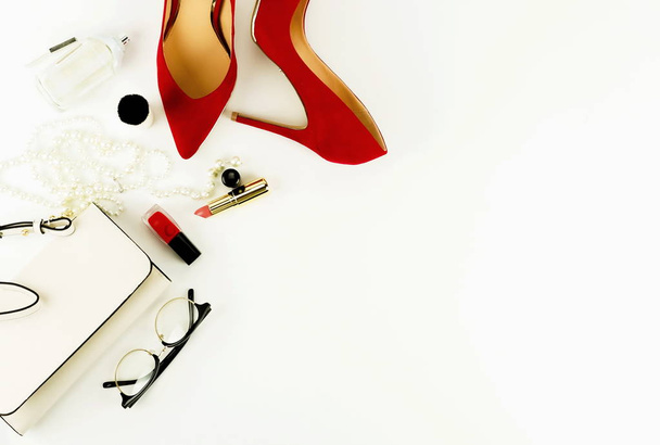 Female fashionable stylish accessories and make up cosmetics. Red shoes with heels, bag,  glasses, lipstick, mascara, powder, brush, parfume on a white background.  Copy space.Flat lay.top view - Fotoğraf, Görsel