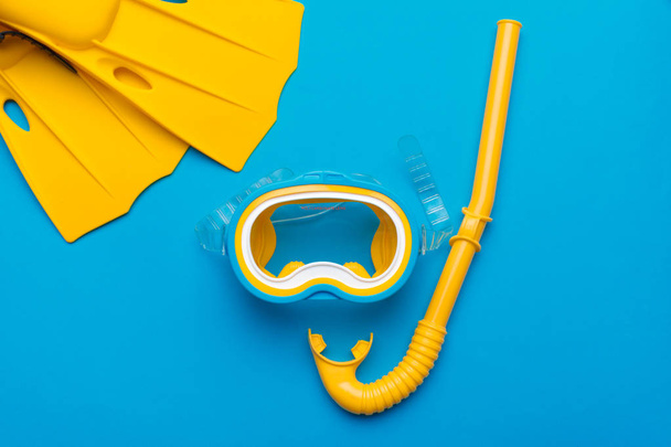 Bright yellow flippers and diving mask on a vibrant backround - Фото, изображение