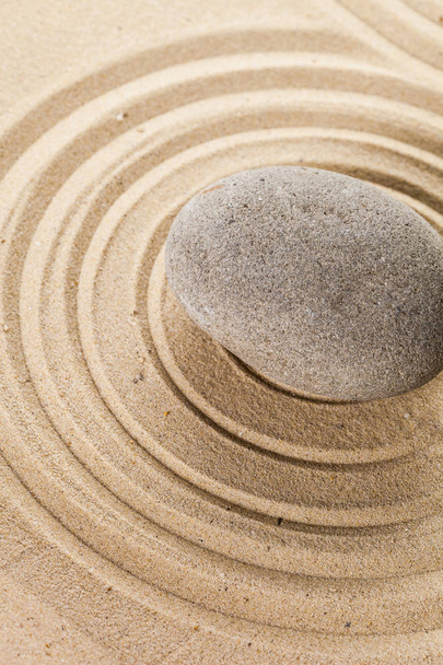 zen meditation stone on sandy background - Foto, afbeelding