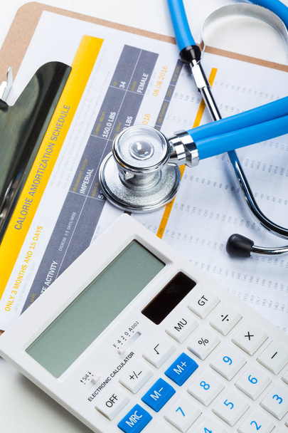 Health care costs. Stethoscope and calculator  - Photo, Image