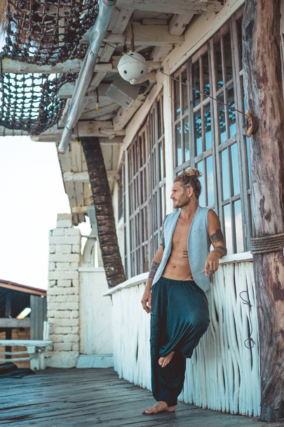 Handsome middle age man with long blond hair and tattoos - Fotó, kép