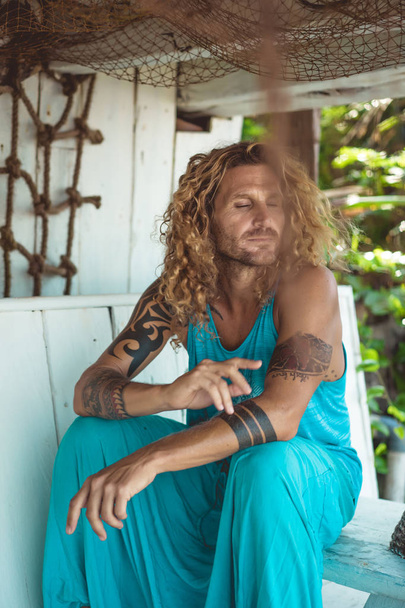 Handsome middle age man with long blond hair and tattoos - Φωτογραφία, εικόνα