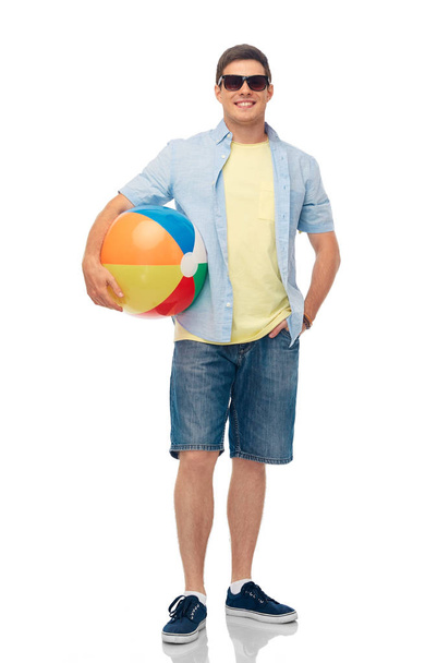 smiling young man in sunglasses with beach ball - Foto, afbeelding