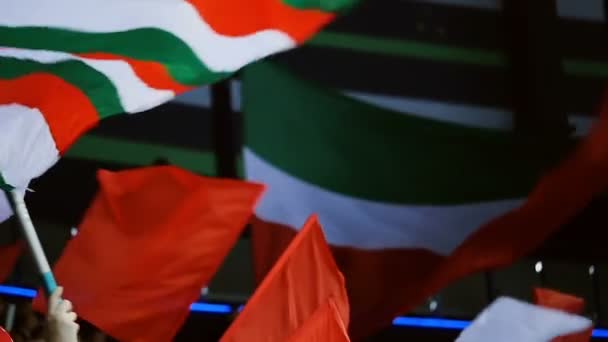 closeup bright flags waved by spectators on modern stadium - 映像、動画