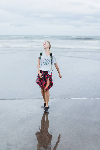 Stylish young woman walking at the seashore - Photo, image