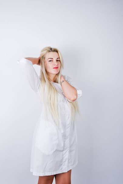 Attractive blonde female doctor or nurse  in lab coat isolated on white background. - Фото, зображення