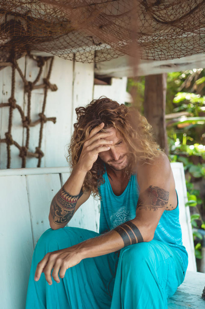 Handsome middle age man with long blond hair and tattoos - Fotoğraf, Görsel
