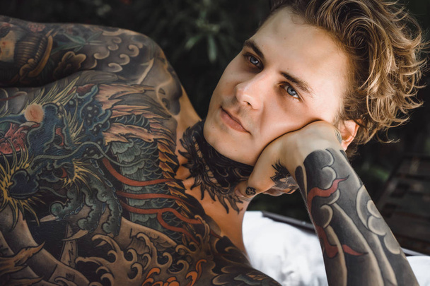Portrait of handsome young man with tattoos  - 写真・画像
