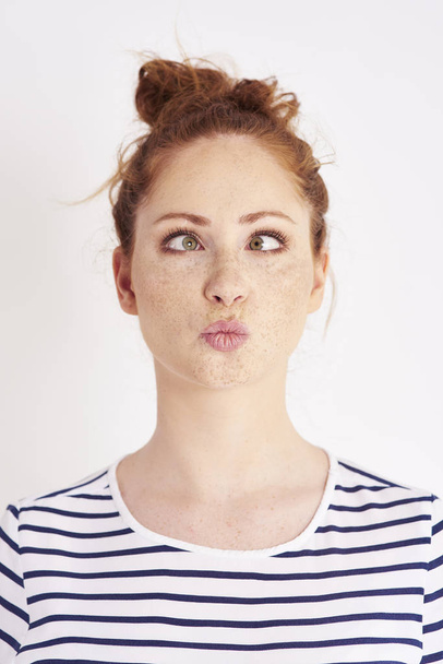 Cross eyed girl making a face at studio shot - Photo, Image