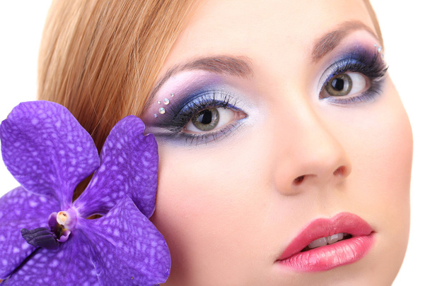 Portrait of beautiful young woman with glamour make up and flower, close up - Zdjęcie, obraz