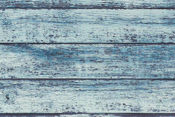 Old blue toned shabby wooden planks with cracked color paint - Fotografie, Obrázek