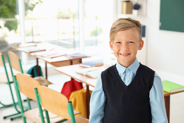 Little boy in classroom. Stylish school uniform - Foto, imagen